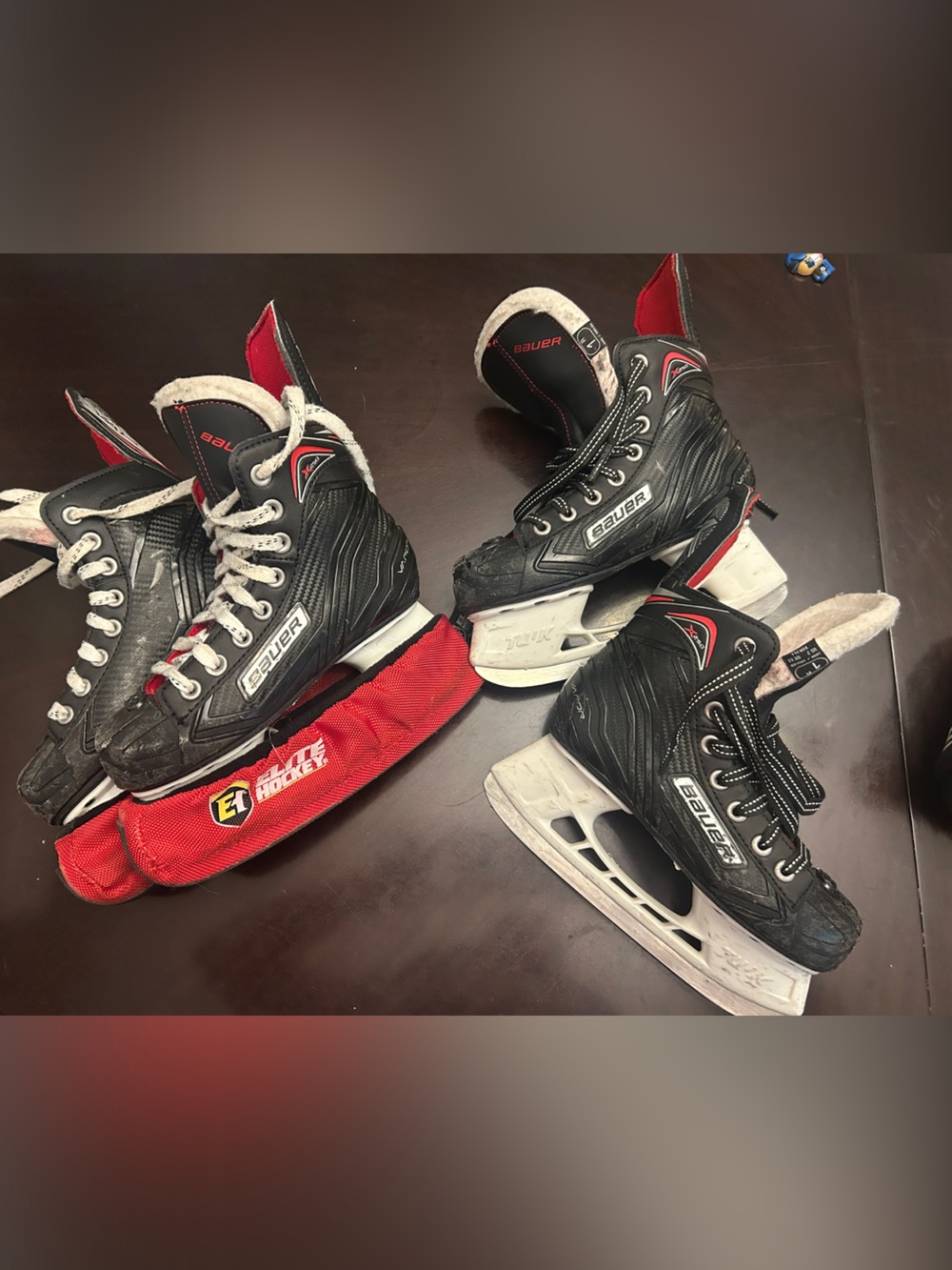 Two pairs of Bauer Vapor X250 Kids Black and Red Ice Hockey Skates.
